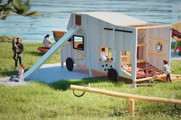 Spielskulptur Wohnmobil in einer virtuellen 3D-Szene. Grüne Wiese mit einzelnen Spielgeräten, in der Mitte das Wohnmobil (Blick von hinten schräg aufs Heck, darin ein Kletternetz, oben verlässt eine Rutsche das Gefährt); Im Hintergrund ein Uferberecih eines Sees